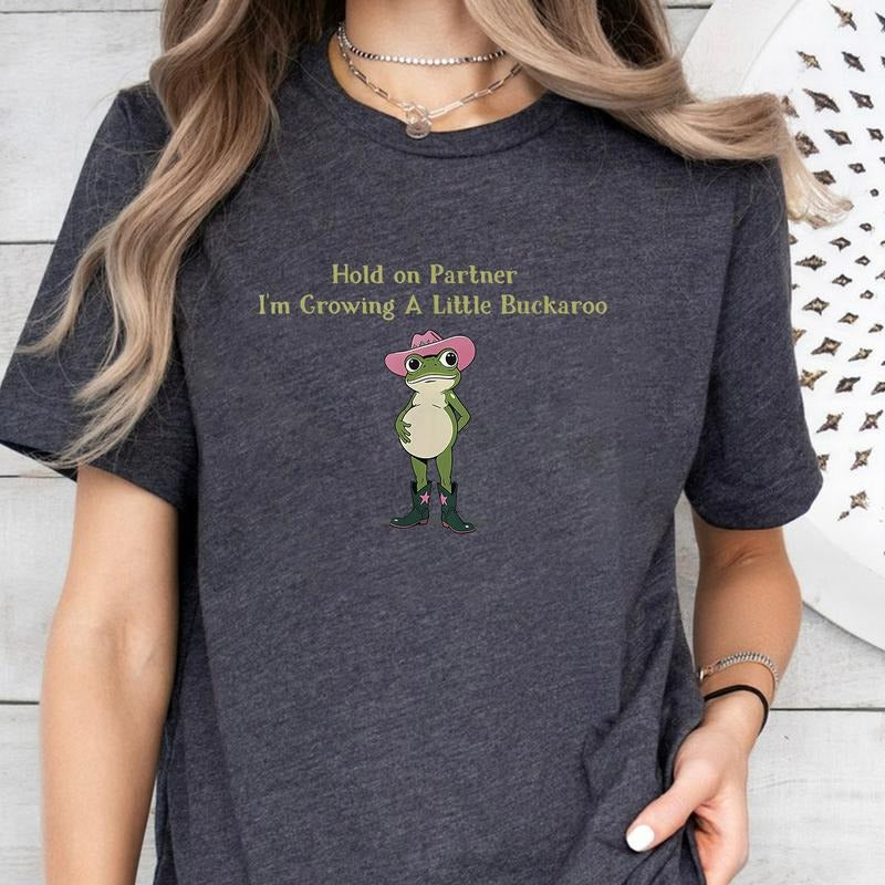 Hold On Partner I'm Growing A Little Buckaroo T-Shirt, Cute Animal T-Shirt, Funny Frog T-Shirt, Unhinged T-Shirt, Pregnancy Reveal T-Shirt, First Time Mom Gift
