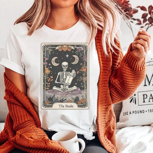 "Reader Tarot Card Shirt, Halloween Shirt, Gothic Reading Skeleton, Great for Writers & Book Lovers, Trendy Halloween T-Shirt." Cotton Crewneck Shortsleeve Casual