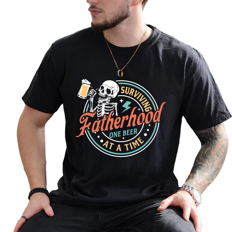 Surviving Fatherhood One Beer At A Time Shirt, Fatherhood Tee, Funny Father Graphic Printed Tee, Sarcastic Drinking Husband Unhinged Shirt, Comfy Fabric Graphic Tee, Father's Day Gift Shirt, Men's Tops, Menswear, Cotton Fabric Tee