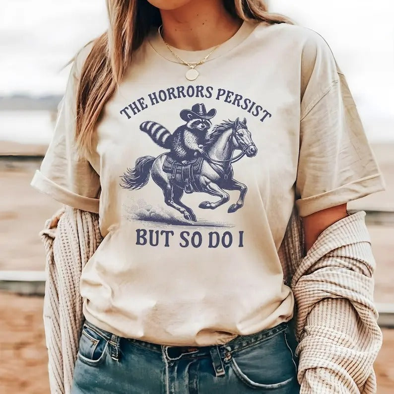 The Horrors Persist But So Do I Raccoon Tshirt Funny Western Shirt Silly Meme Gift Weird Trash Panda Top, Retro 90s Graphic Womenswear Streetwear
