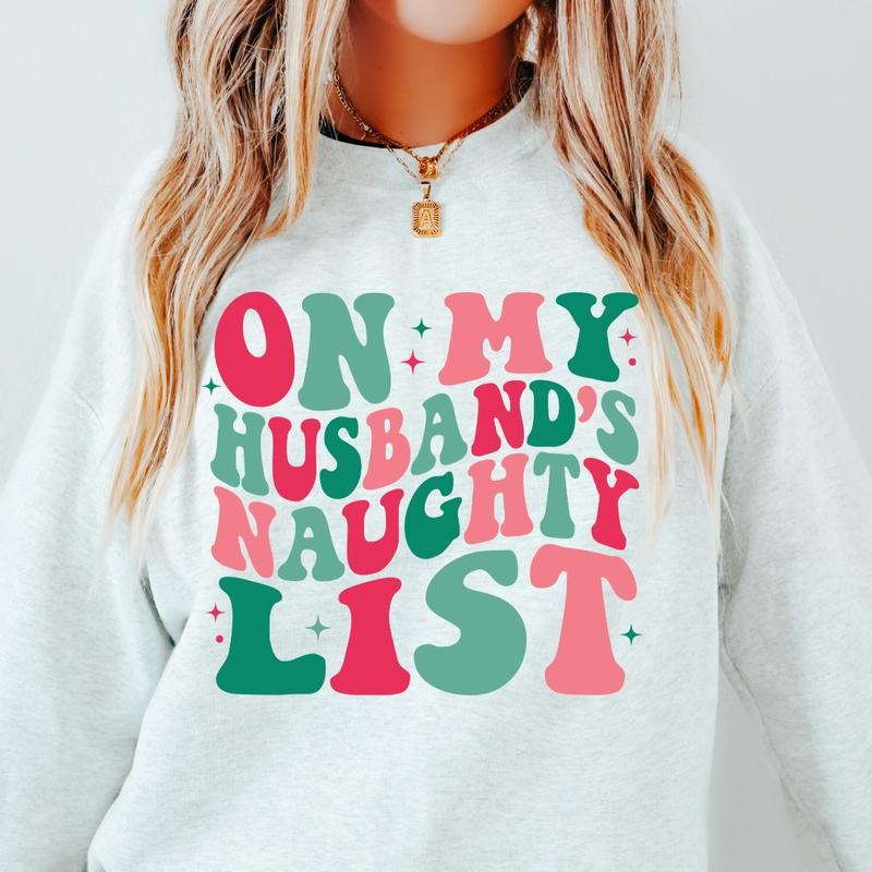 ON MY HUSBANDS NAUGHTY LIST SWEATSHIRT ( CHRISTMAS CREWNECK HOLIDAY CREWNECK SWEATSHIRT, RUNS TRUE TO SIZE GO UP ONE SIZE FOR THE OVERSIZED LOOK CASUAL WEAR HOLIDAY APPAREL) Womenswear Hoodie
