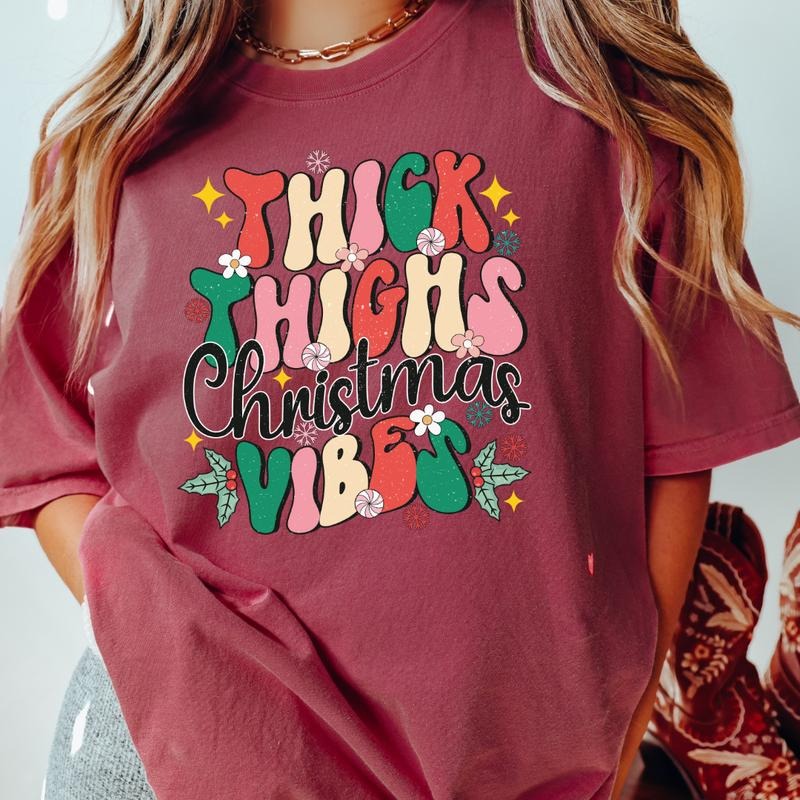 THICK THIGHS AND CHRISTMAS VIBES T-SHIRT (COMFORT COLORS T-SHIRT, CASUAL SHIRT UNISEX, CHRISTMAS CLOTHING, GRAPHIC APPAREL, HOLIDAY SHIRT) Cotton Fabric