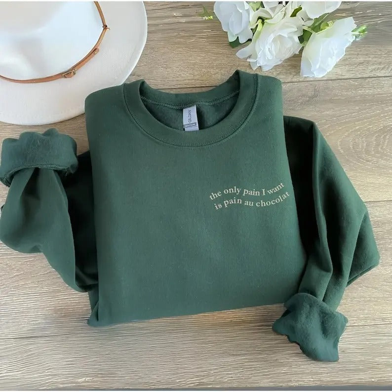 The only pain I want is pain au chocolat oversize sweater green Pinterest trendy aesthetic winter warm quote cozy hoodie funny wavy letters